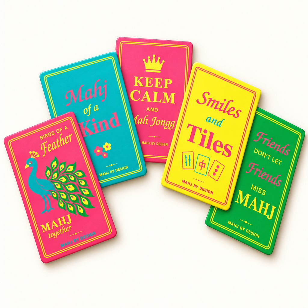 Five rectangular Signature mahjong shufflers arranged in a colorful fan on a warm ivory background, including the peacock. Digital product rendering.
