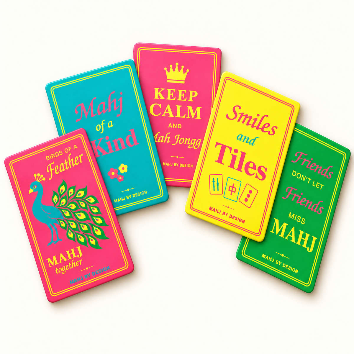 Five rectangular Signature mahjong shufflers arranged in a colorful fan on a warm ivory background, including the peacock. Digital product rendering.