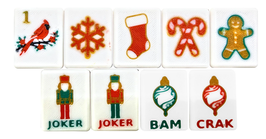 Actual Christmas tile artwork: cardinal, snowflake, stocking, candy canes, gold gingerbread, both nutcracker Jokers and BAM and CRAK dragons.