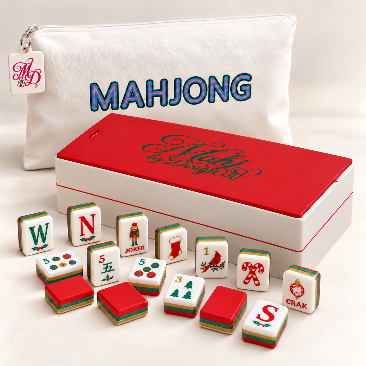 Christmas mahjong tiles with red-lidded storage box and tagged white bag. Digital product rendering.