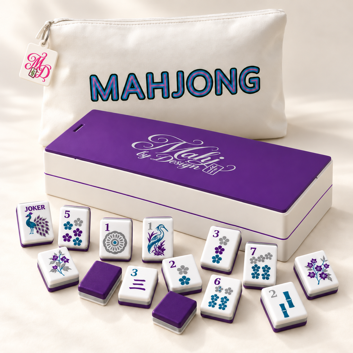 Purple Signature mahjong tiles with coordinating storage box and tagged white bag. Digital product rendering.